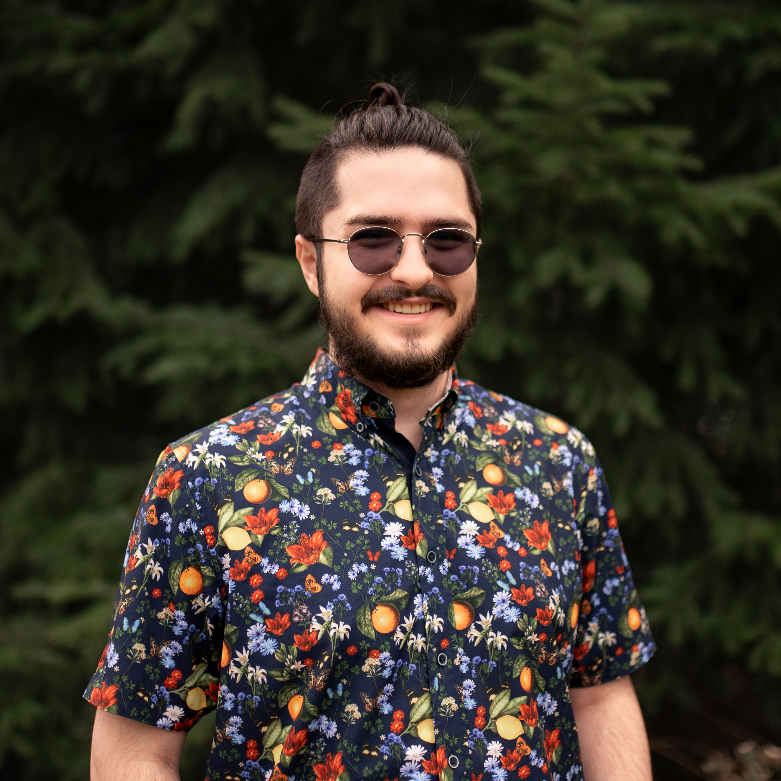 Headshot of Nicholas Robinson smiling and wearing a floral shirt